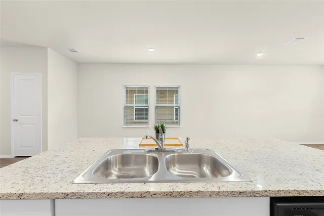 a kitchen with granite countertop a sink and a granite counter tops