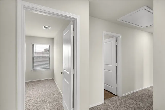 a view of a hallway to rooms