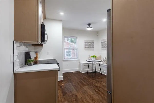 a kitchen with a sink cabinets and wooden floor