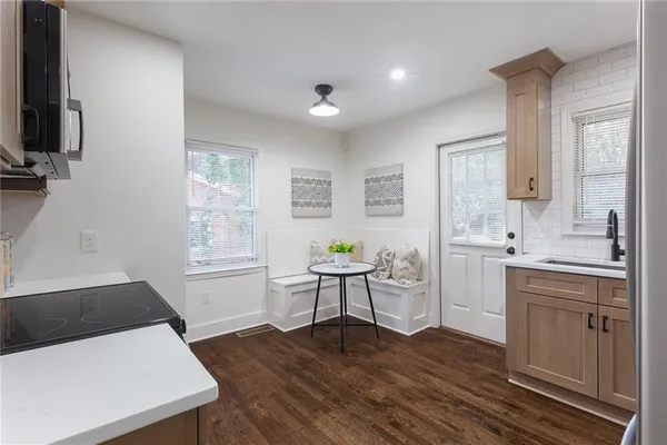 a kitchen with a table and chairs in it