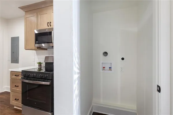a kitchen with a refrigerator and a stove top oven
