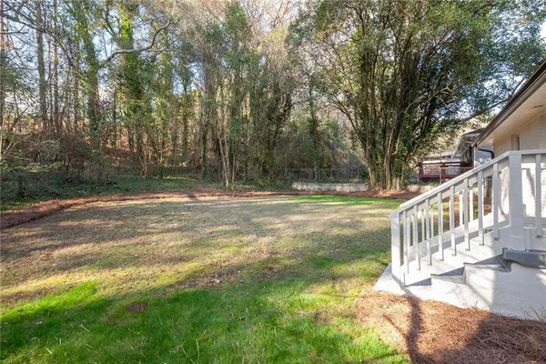 a view of a yard with large trees