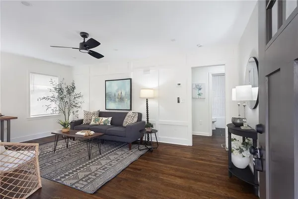 a living room with furniture and wooden floor