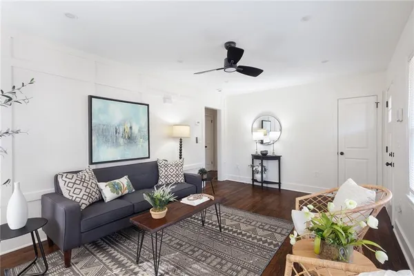 a living room with furniture and wooden floor
