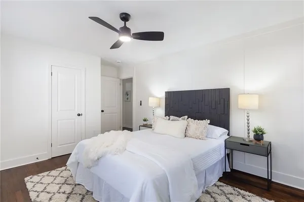 a bedroom with a bed and a lamp