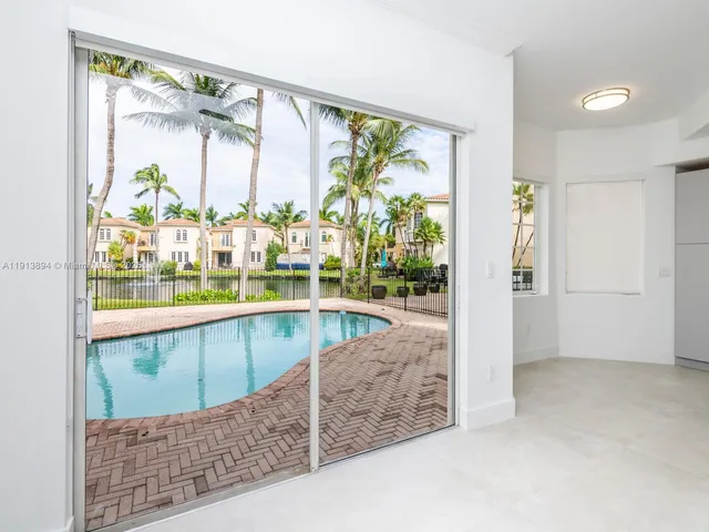 a bathroom with double vanity sink a two mirror a window and a bathtub