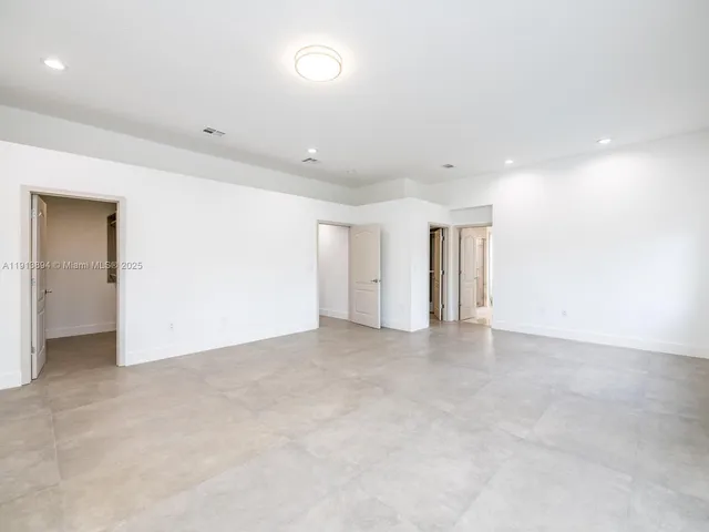 an aerial view of a house with a yard and lake view