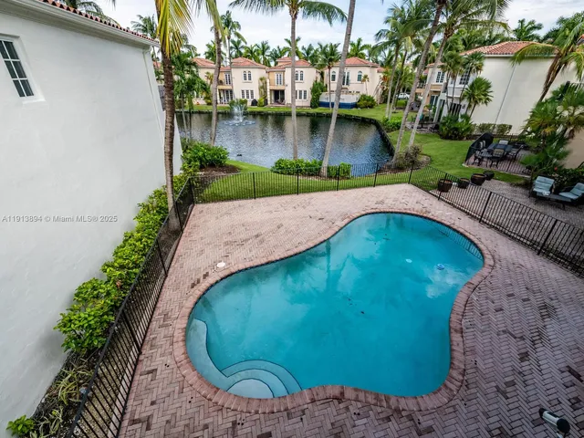 a view of a swimming pool with a yard