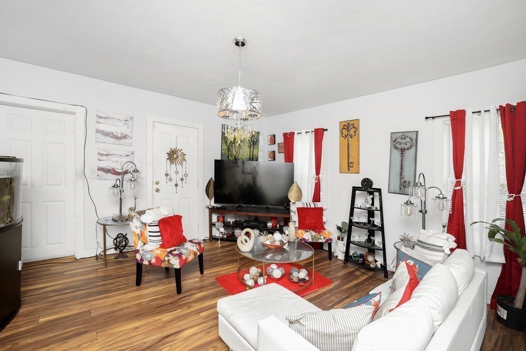 129 Branch Street Fall River, MA 02721 - Photo 4 of 13 a living room with furniture and a flat screen tv