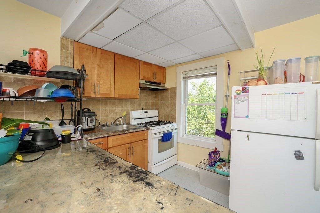 129 Branch Street Fall River, MA 02721 - Photo 7 of 13 a kitchen with a refrigerator and a stove