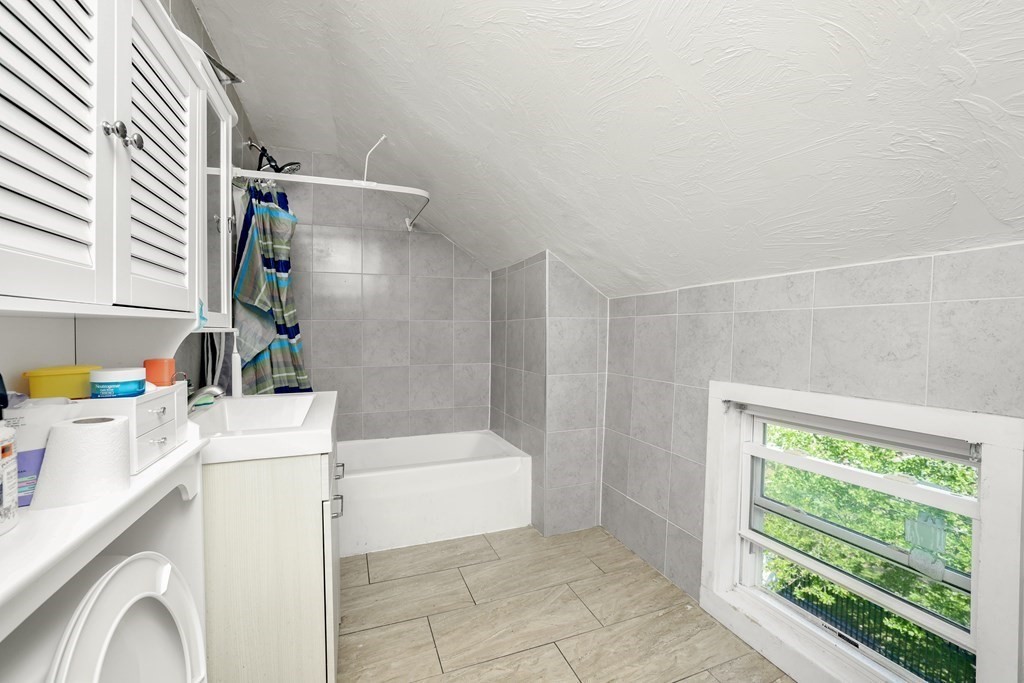129 Branch Street Fall River, MA 02721 - Photo 10 of 13 a bathroom with a bathtub and a sink