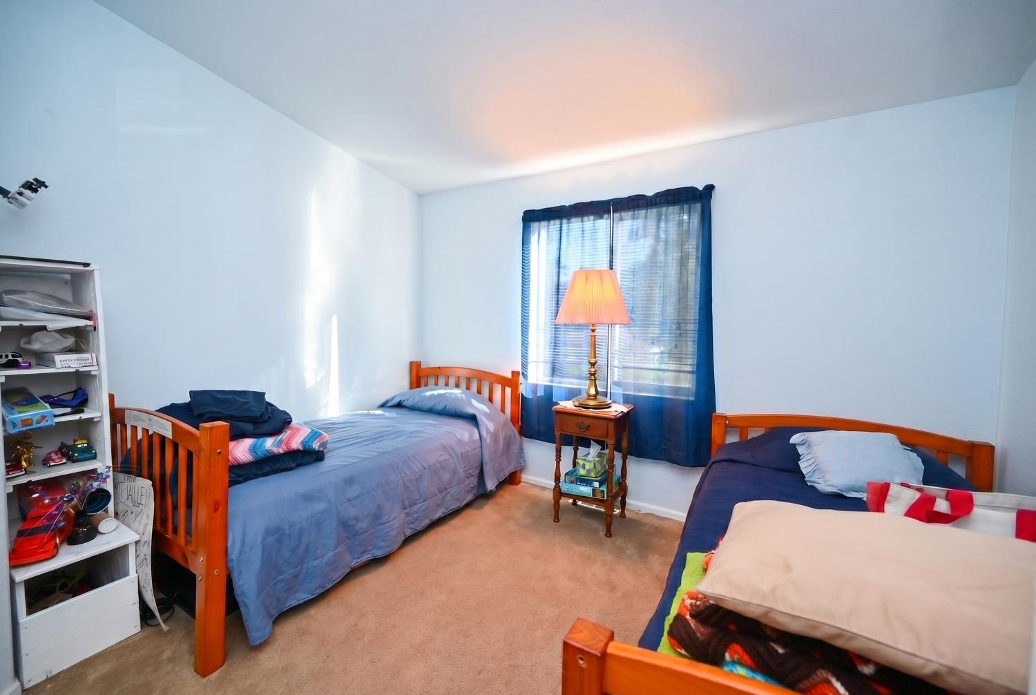 4360 Pleasant Valley Road Placerville, CA 95667 - Photo 57 of 71 a bedroom with furniture and a book shelf