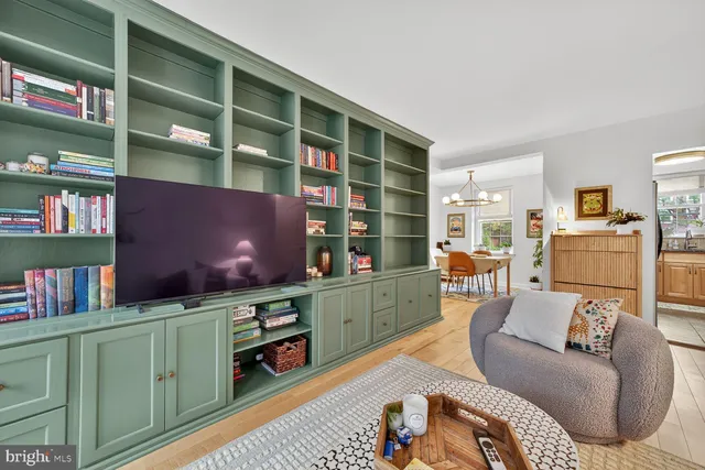 a living room with furniture and a bookshelf