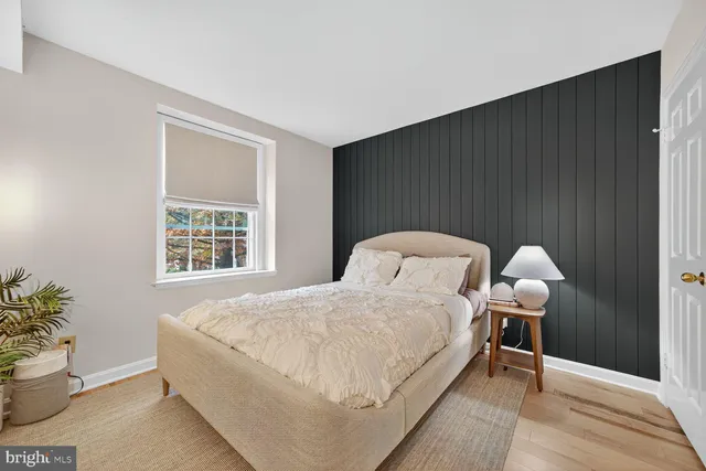 a bedroom with a bed and a potted plant