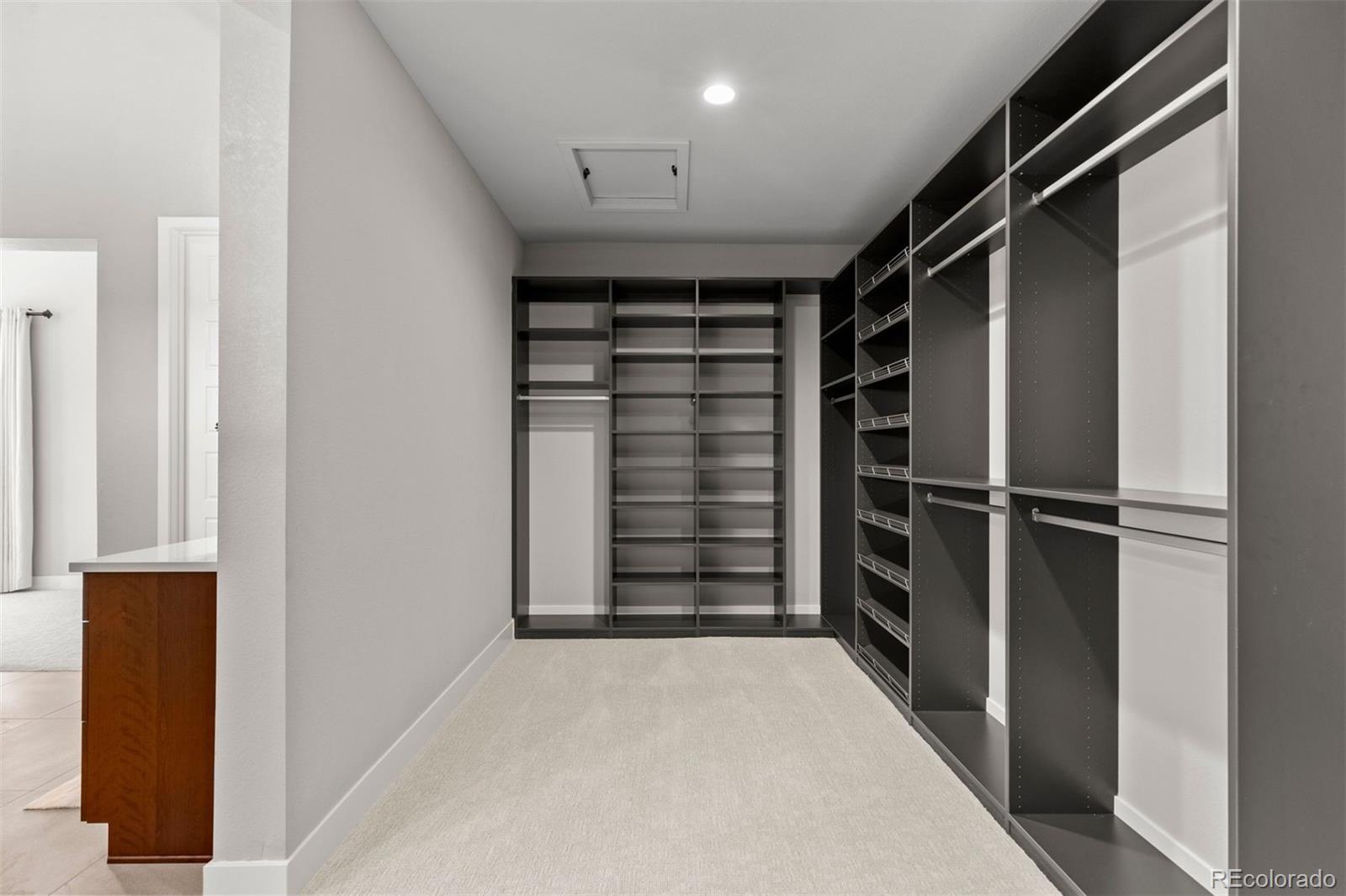 2230 Rim Ridge Drive Castle Pines, CO 80108 - Photo 14 of 33 a view of walk in closet with clothes