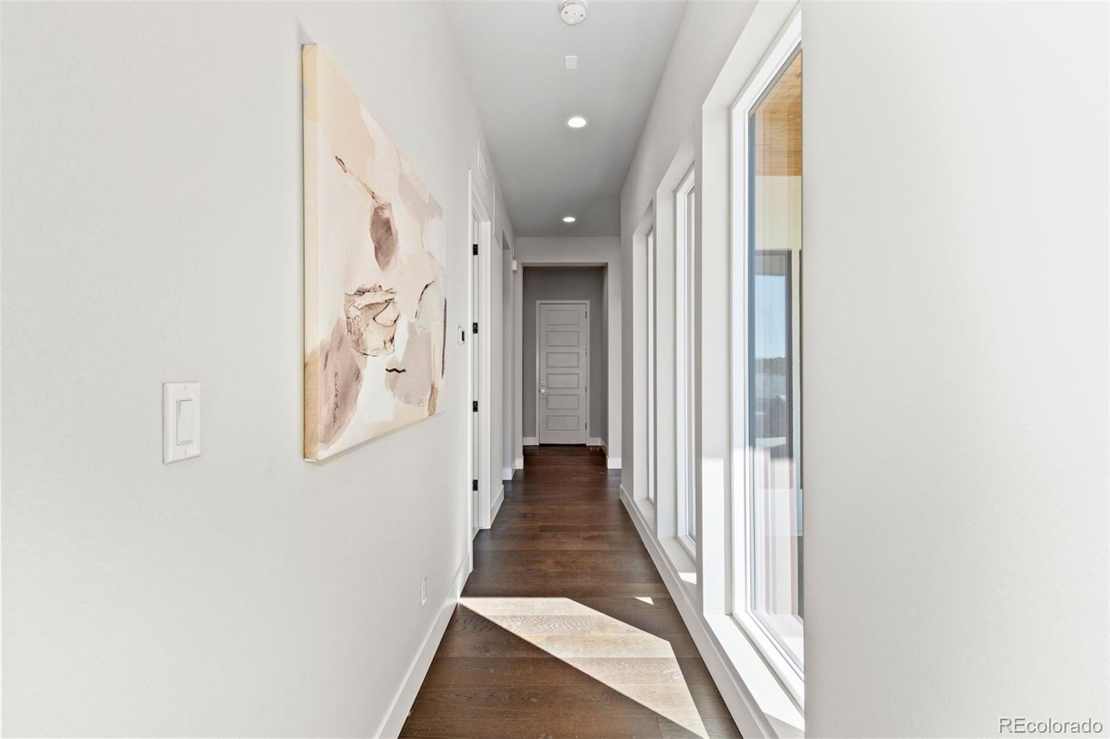 2230 Rim Ridge Drive Castle Pines, CO 80108 - Photo 30 of 33 a view of a hallway with wooden floor