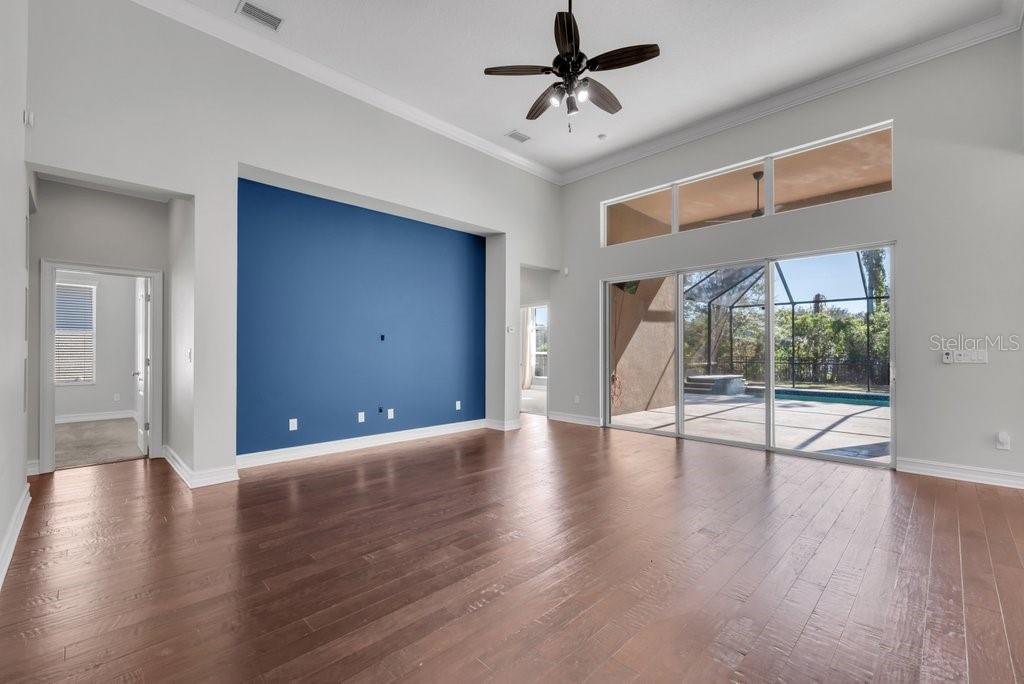 15607 Sunset Run Lane Lithia, FL 33547 - Photo 11 of 54 a view of an empty room with wooden floor and a window