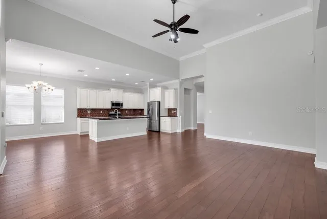 a view of kitchen with refrigerator and window