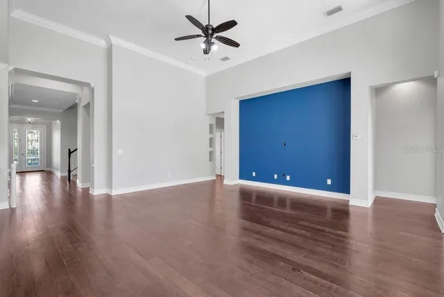 a view of an empty room with wooden floor