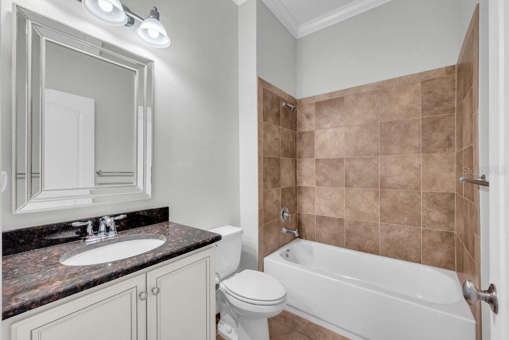 15607 Sunset Run Lane Lithia, FL 33547 - Photo 20 of 54 a bathroom with a granite countertop sink a toilet and bathtub