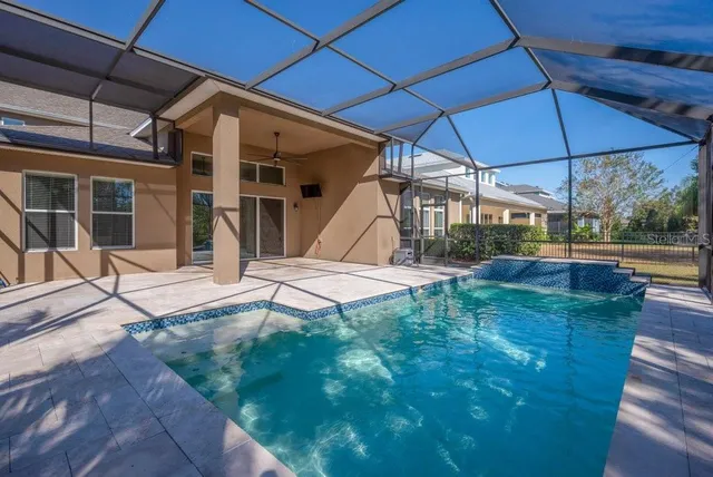 a view of a backyard with table and chairs under an umbrella