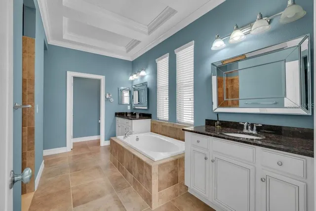a large white kitchen with granite countertop a sink