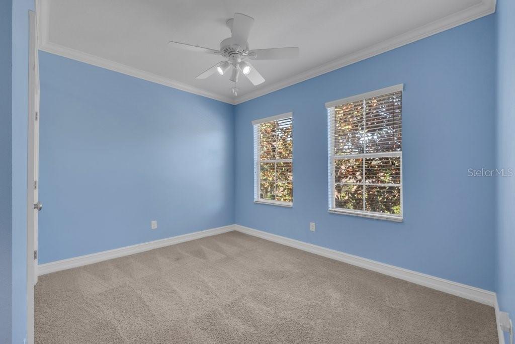 15607 Sunset Run Lane Lithia, FL 33547 - Photo 33 of 54 an empty room with windows and chandelier fan