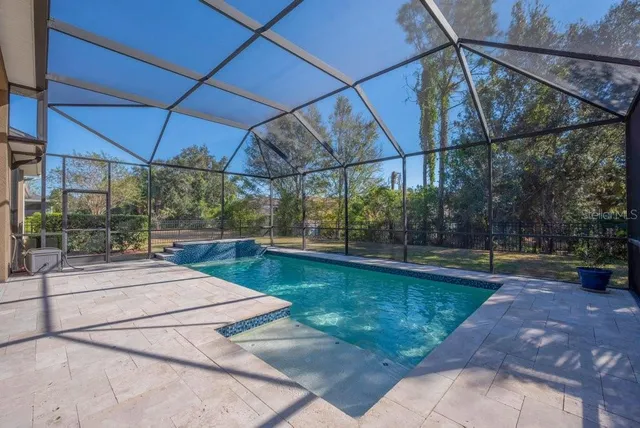 a view of a backyard with table and chairs under an umbrella