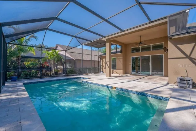 a view of a house with swimming pool and sitting area