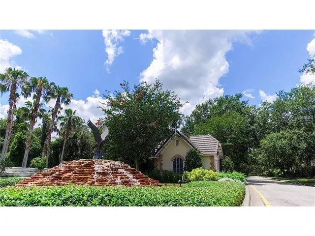 a view of a house with a yard and potted plants