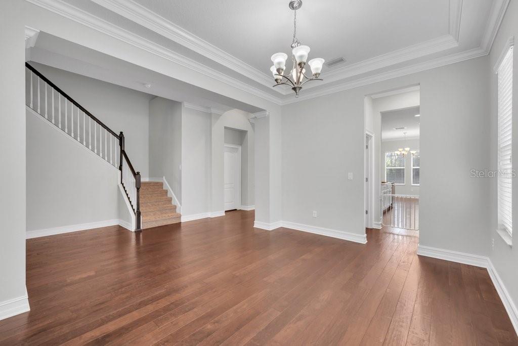 15607 Sunset Run Lane Lithia, FL 33547 - Photo 8 of 54 a view of an empty room with wooden floor and staircase