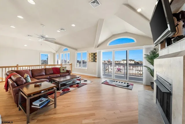 a kitchen with stainless steel appliances kitchen island granite countertop a stove and white cabinets