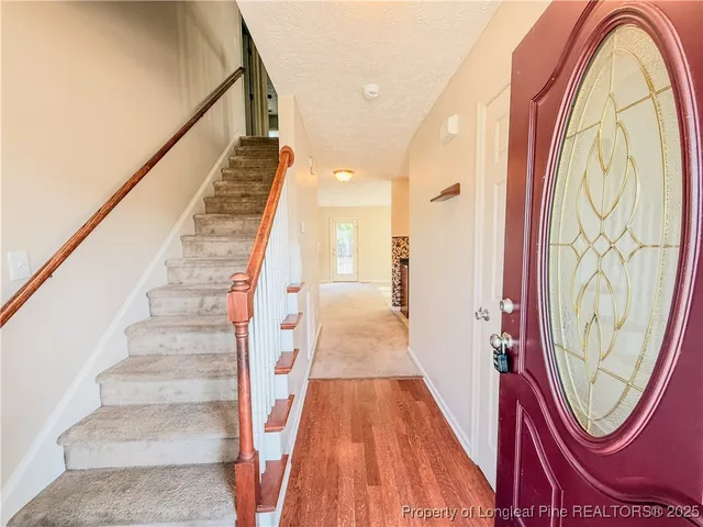 a kitchen with stainless steel appliances granite countertop a sink a stove and refrigerator