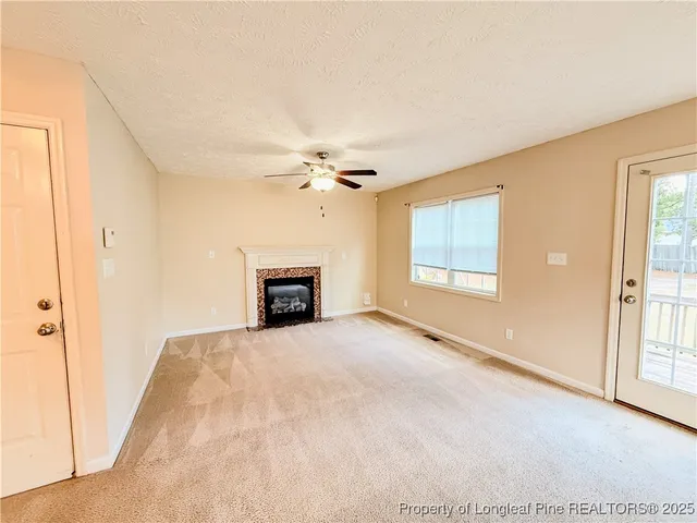 a view of a room with a ceiling fan and a window
