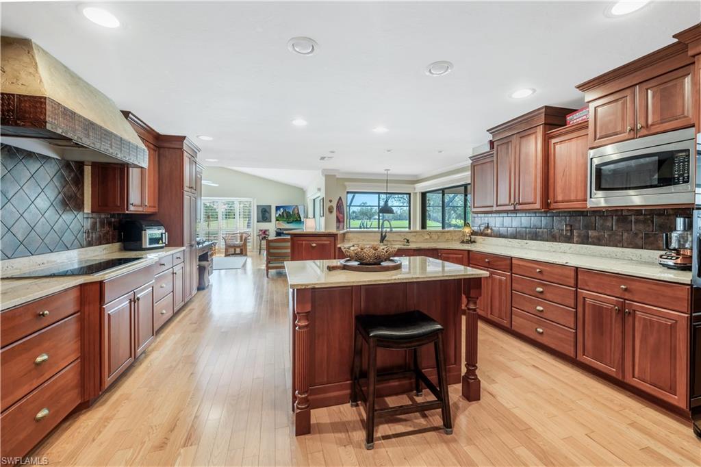 2256 Imperial Golf Course Boulevard Naples, FL 34110 - Photo 16 of 49 Expanded kitchen with center island warming drawer.