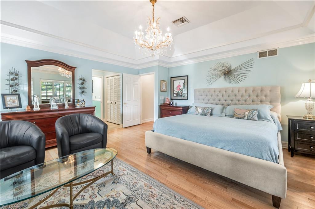 2256 Imperial Golf Course Boulevard Naples, FL 34110 - Photo 31 of 49 Waterfront Master suite with sitting area & wood flooring.