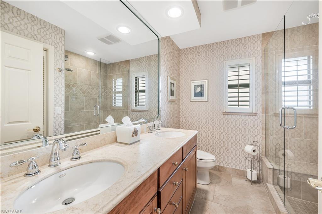 2256 Imperial Golf Course Boulevard Naples, FL 34110 - Photo 42 of 49 Marble guest bath with dual sinks & frameless shower.