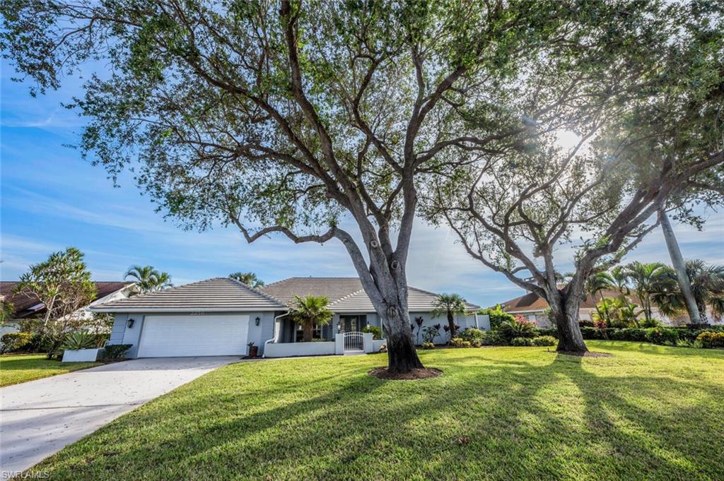 2256 Imperial Golf Course Boulevard Naples, FL 34110 - Photo 48 of 49 Spacious front lawn with mature shade trees.