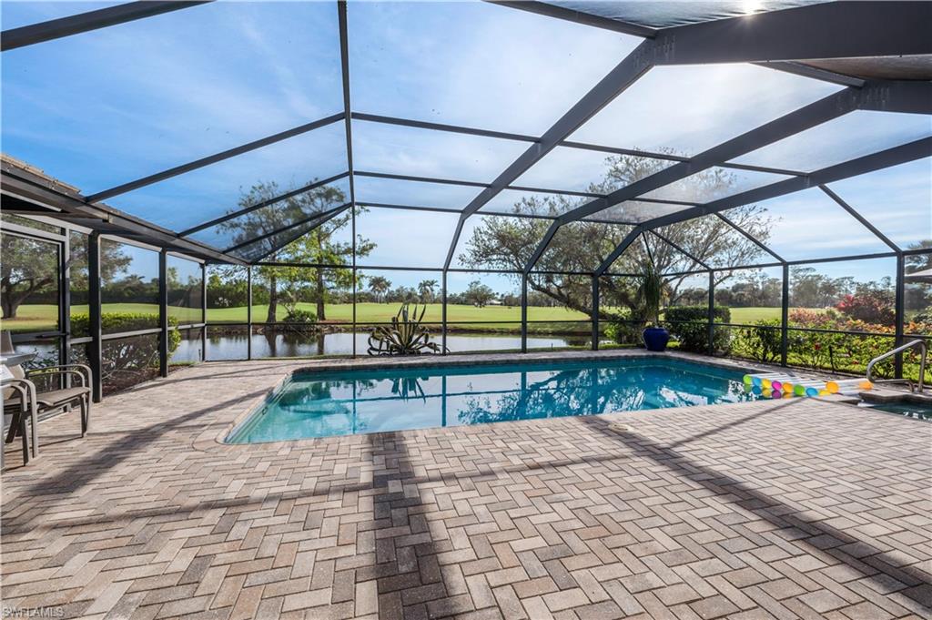 2256 Imperial Golf Course Boulevard Naples, FL 34110 - Photo 8 of 49 Waterfront Oversize screened pool, spa & brick paver deck