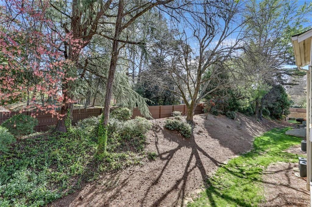 3445 Ivys Walk Atlanta, GA 30340 - Photo 17 of 21 a view of a garden with plants and large trees