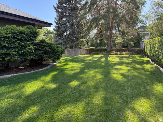 362 East 9150th Street South Sandy, UT 84070 - Photo 19 of 41 Expansive lawn area featuring mature trees and established perimeter landscaping
