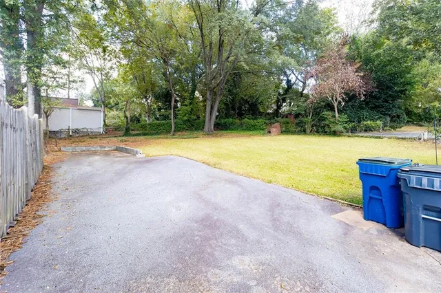 a view of a swimming pool and trees in the background
