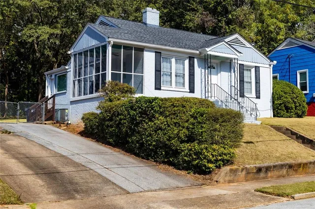 a front view of a house with a garden
