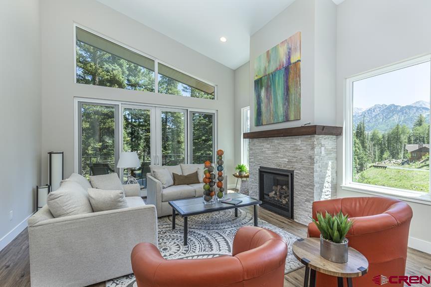 115 Travertine Trail, Unit PHASE III 4 Durango, CO 81301 - Photo 16 of 34 a living room with furniture a large window and a fireplace