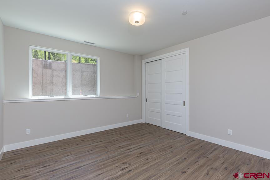 115 Travertine Trail, Unit PHASE III 4 Durango, CO 81301 - Photo 21 of 34 a view of empty room with wooden floor and fan