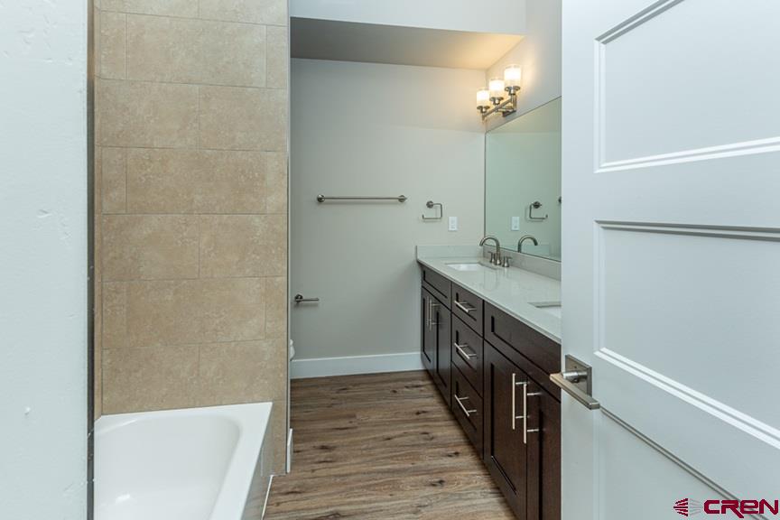 115 Travertine Trail, Unit PHASE III 4 Durango, CO 81301 - Photo 22 of 34 a bathroom with a sink a shower and a mirror