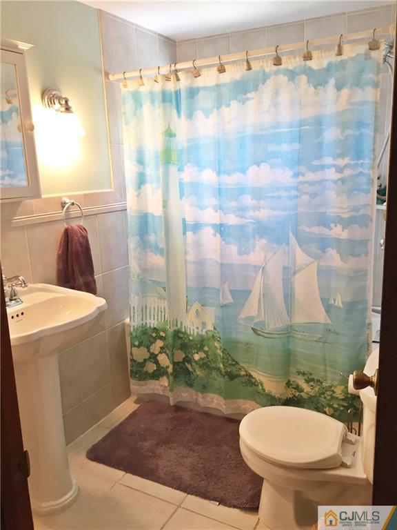 9 Sine Road Edison, NJ 08817 - Photo 13 of 21 a bathroom with a sink toilet and shower