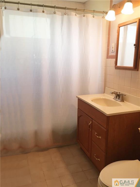 9 Sine Road Edison, NJ 08817 - Photo 14 of 21 a bathroom with a sink vanity mirror and toilet