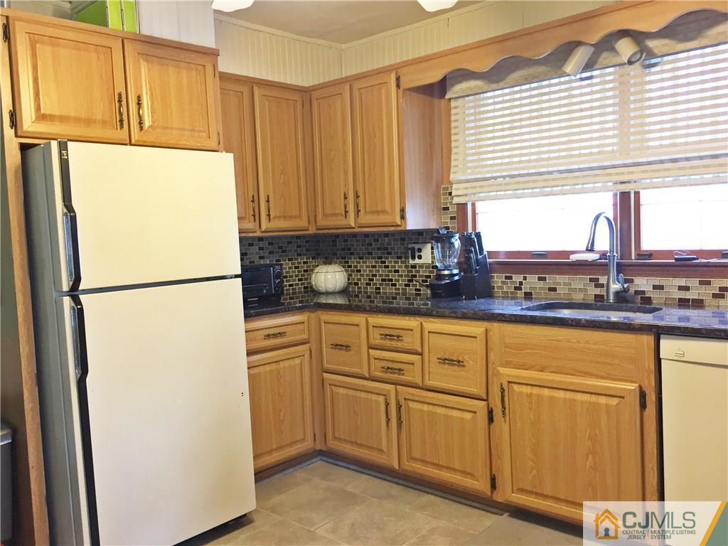 9 Sine Road Edison, NJ 08817 - Photo 4 of 21 a kitchen with stainless steel appliances granite countertop a refrigerator sink and cabinets