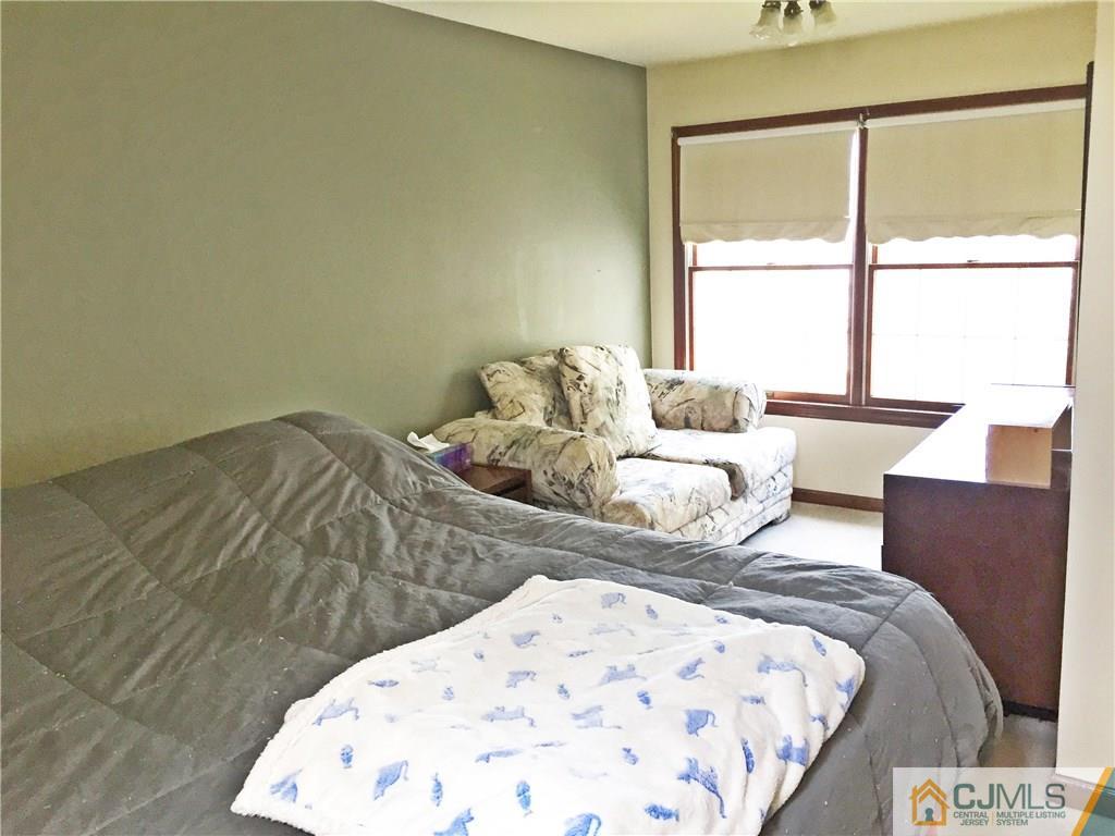 9 Sine Road Edison, NJ 08817 - Photo 8 of 21 a bedroom with a bed and wooden floor